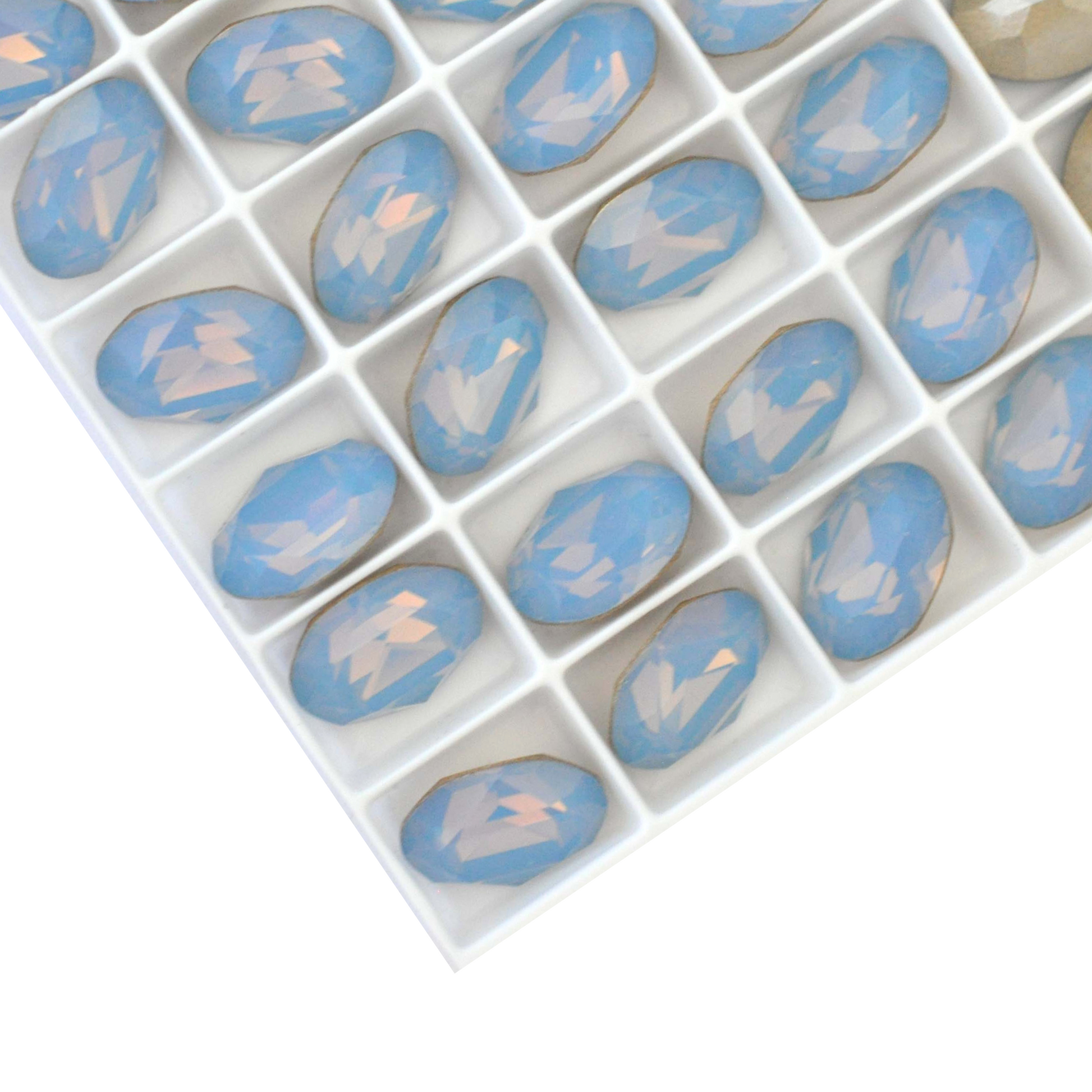 Oval shape faceted Austrian crystal rhinestones in the color Air Blue Opal displayed on a white background.