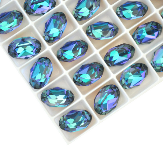 Oval shape faceted Austrian crystal rhinestones in the color Aqua Vitrail Light displayed on a white background.