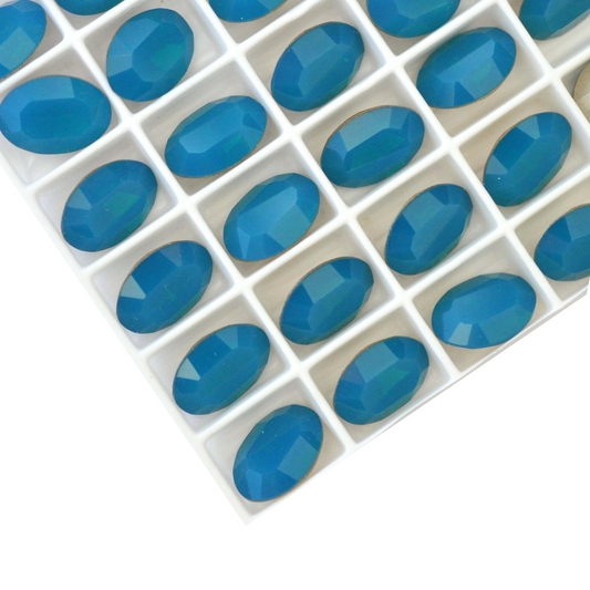 Oval shape faceted Austrian crystal rhinestones in the color Caribbean Blue Opal displayed on a white background.