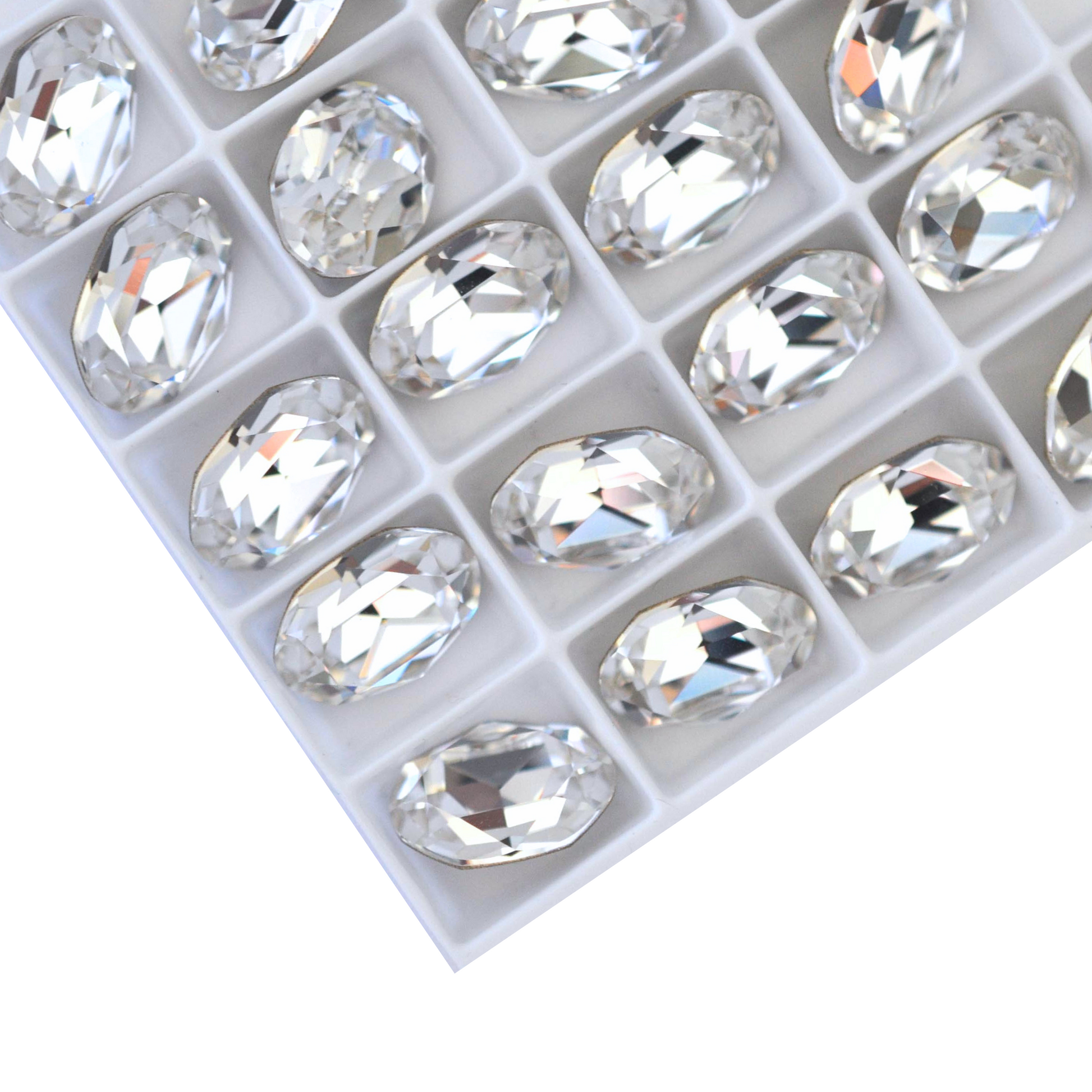 Oval shape faceted Austrian crystal rhinestones in the color Crystal Clear displayed on a white background.