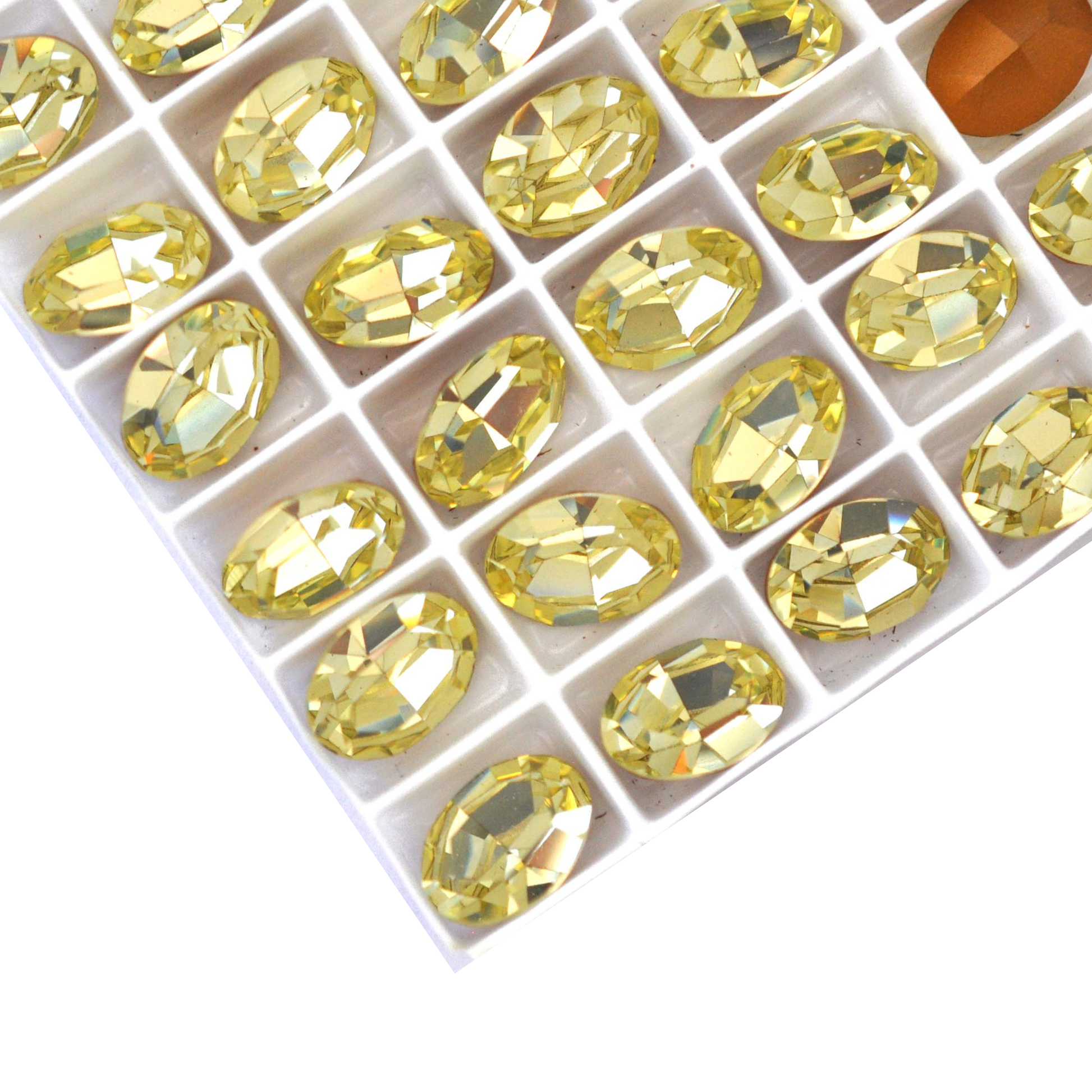 Oval shape faceted Austrian crystal rhinestones in the color Jonquil displayed on a white background.