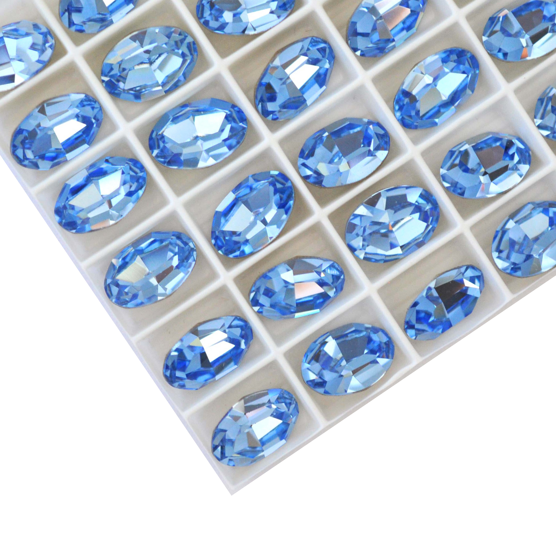 Oval shape faceted Austrian crystal rhinestones in the color Light Sapphire displayed on a white background.
