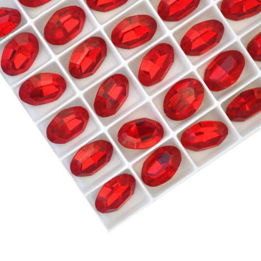 Oval shape faceted Austrian crystal rhinestones in the color Light Siam displayed on a white background.