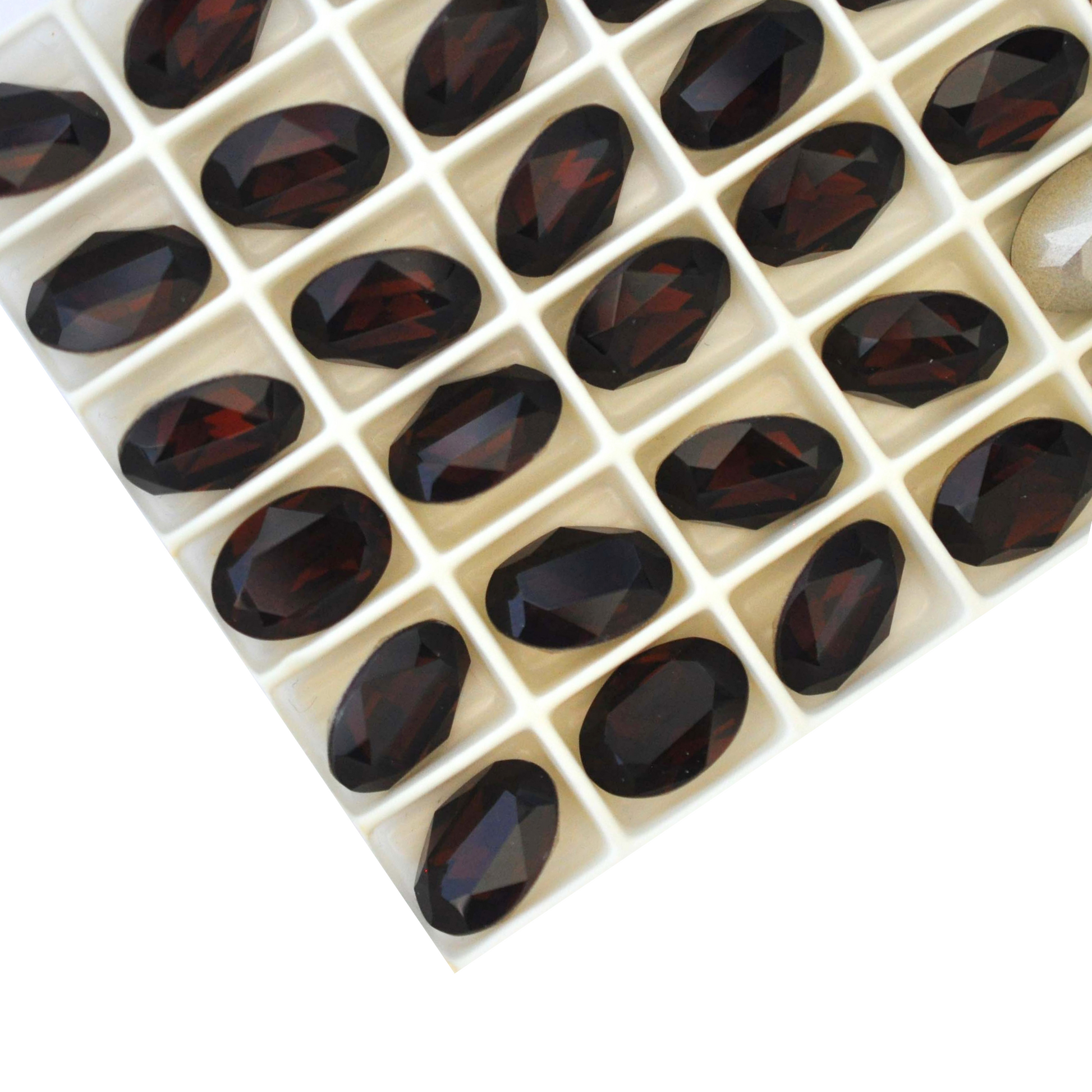 Oval shape faceted Austrian crystal rhinestones in the color Mocca displayed on a white background.