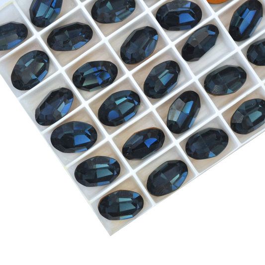 Oval shape faceted Austrian crystal rhinestones in the color Montana displayed on a white background.