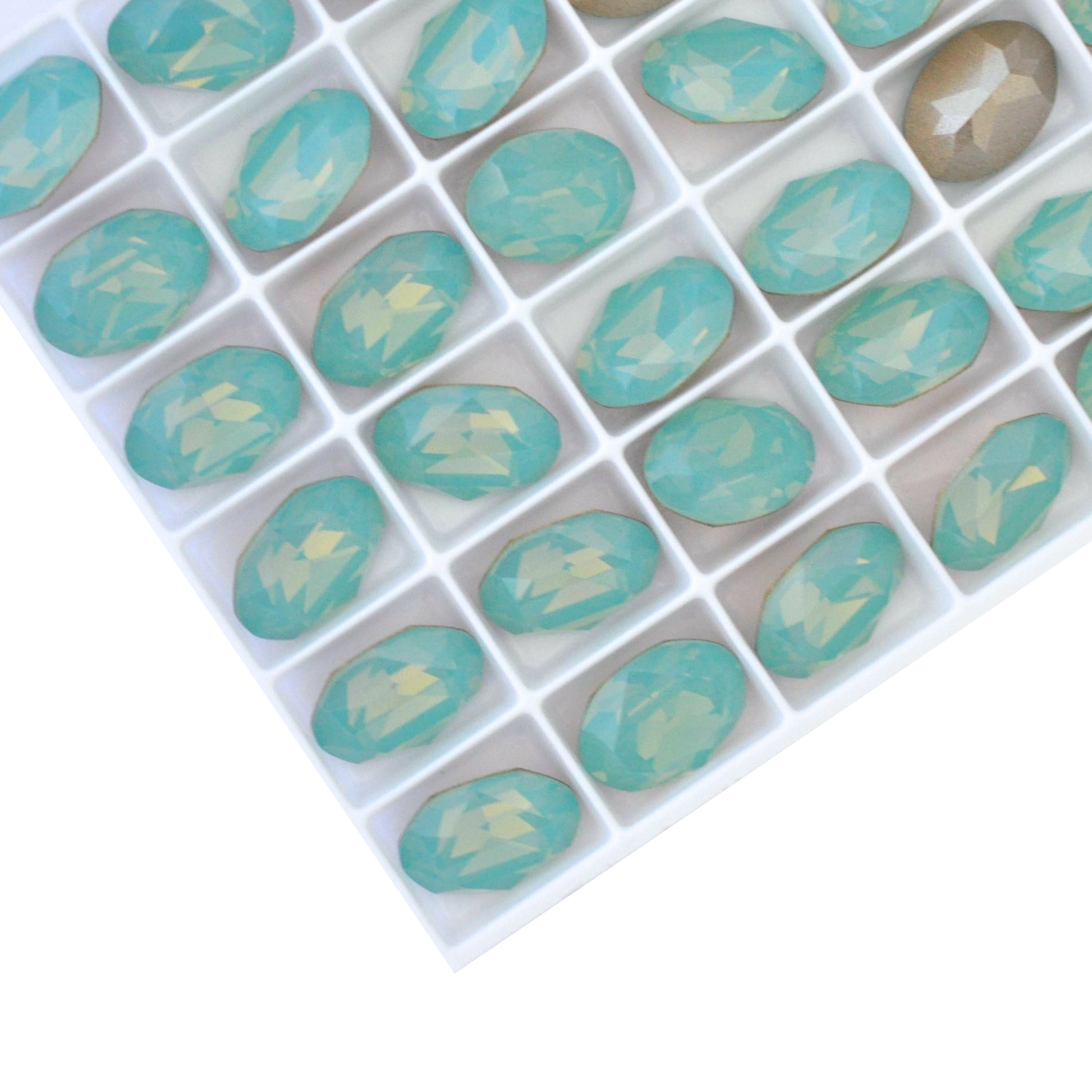 Oval shape faceted Austrian crystal rhinestones in the color Pacific Opal displayed on a white background.
