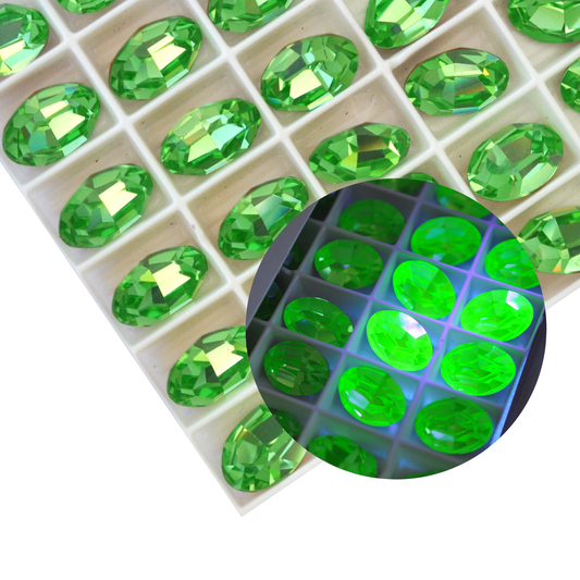 Oval shape faceted Austrian crystal rhinestones in the color Peridot displayed on a white background.