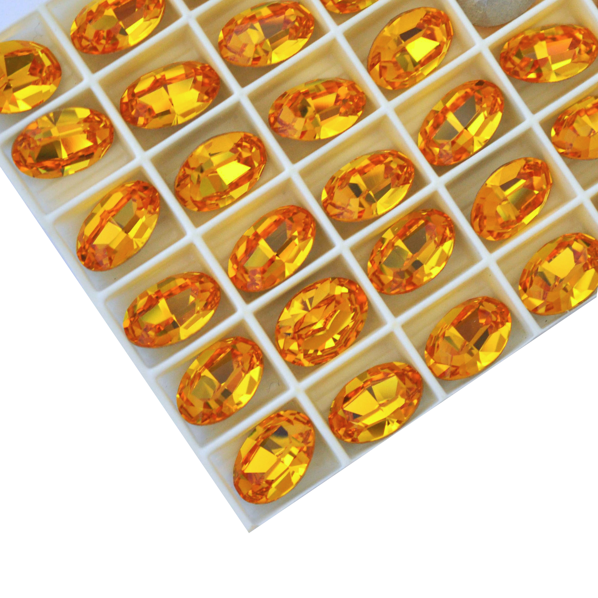 Oval shape faceted Austrian crystal rhinestones in the color Sunflower displayed on a white background.