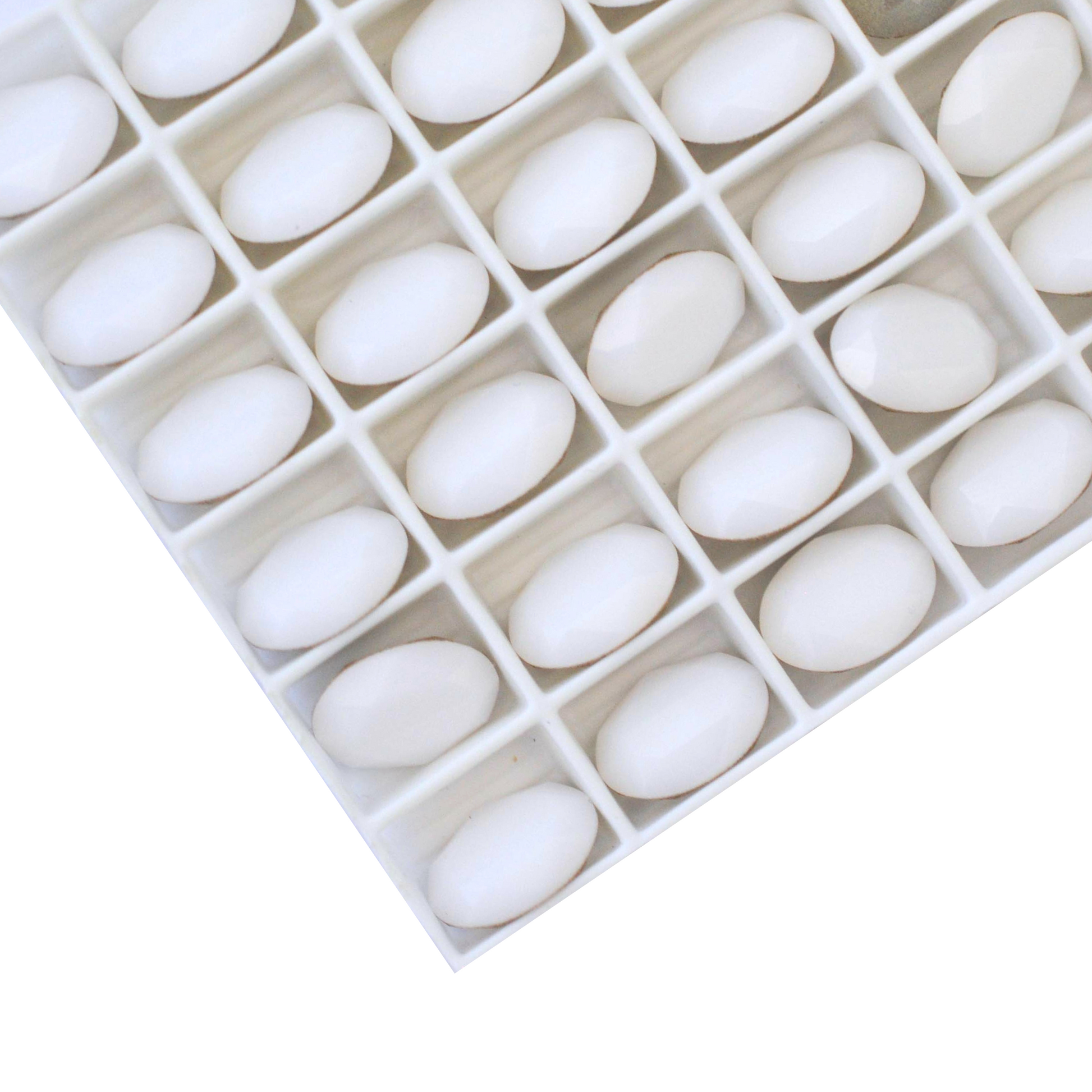 Oval shape faceted Austrian crystal rhinestones in the color White Alabaster displayed on a white background.