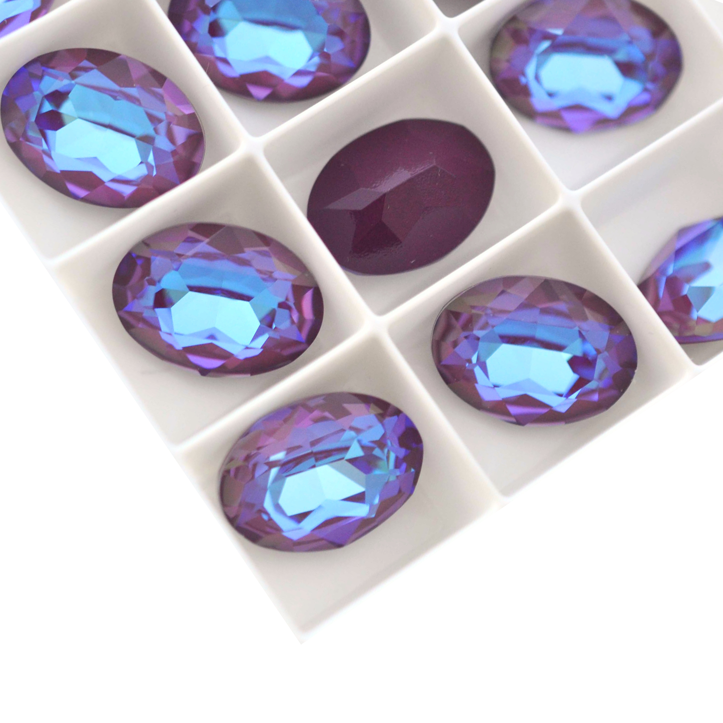 Oval shape faceted Austrian crystal rhinestones in the color Burgundy Delite displayed on a white background.