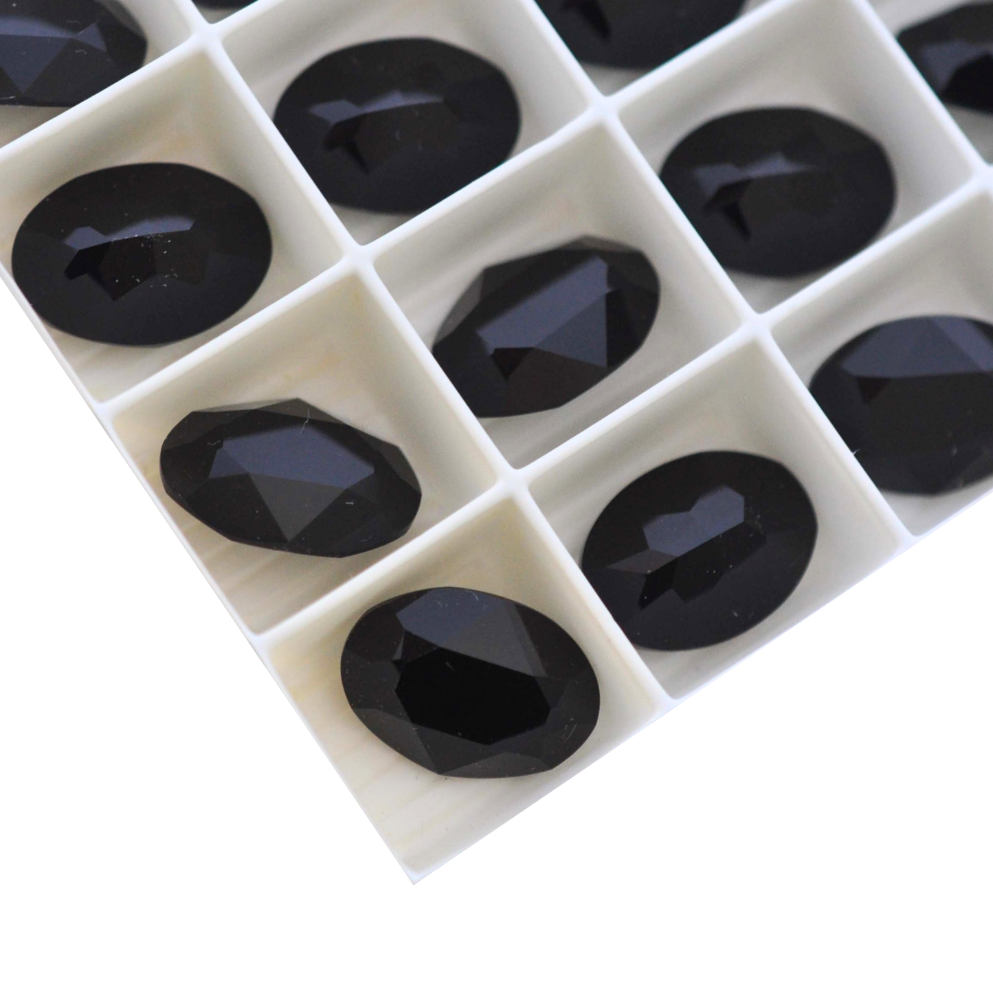 Oval shape faceted Austrian crystal rhinestones in the color Jet displayed on a white background.
