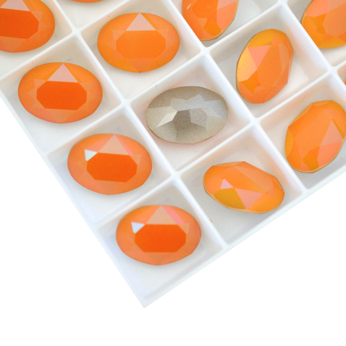 Oval shape faceted Austrian crystal rhinestones in the color Orange Sorbet displayed on a white background.