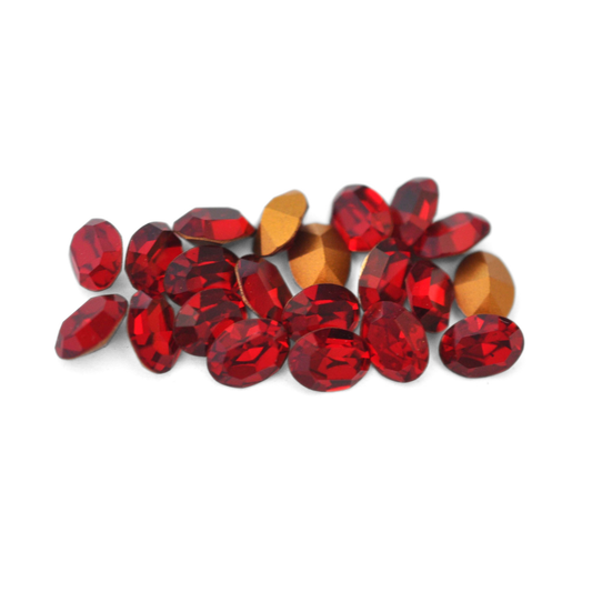 Oval shaped faceted Austrian crystal rhinestones in the color Siam displayed on a white background.