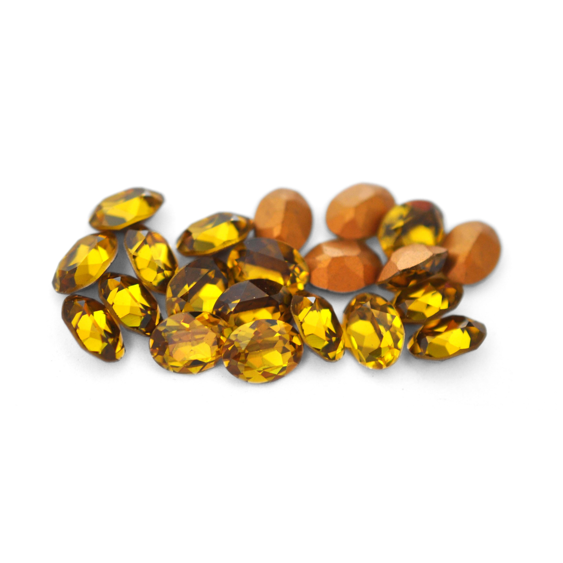 Oval shaped faceted Austrian crystal rhinestones in the color Vintage Lime displayed on a white background.