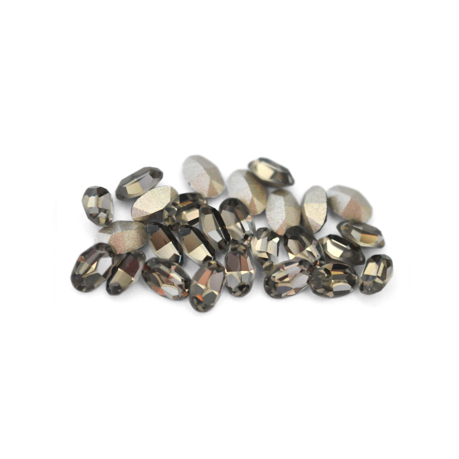 Oval shaped faceted Austrian crystal rhinestones in the color Black Diamond displayed on a white background.