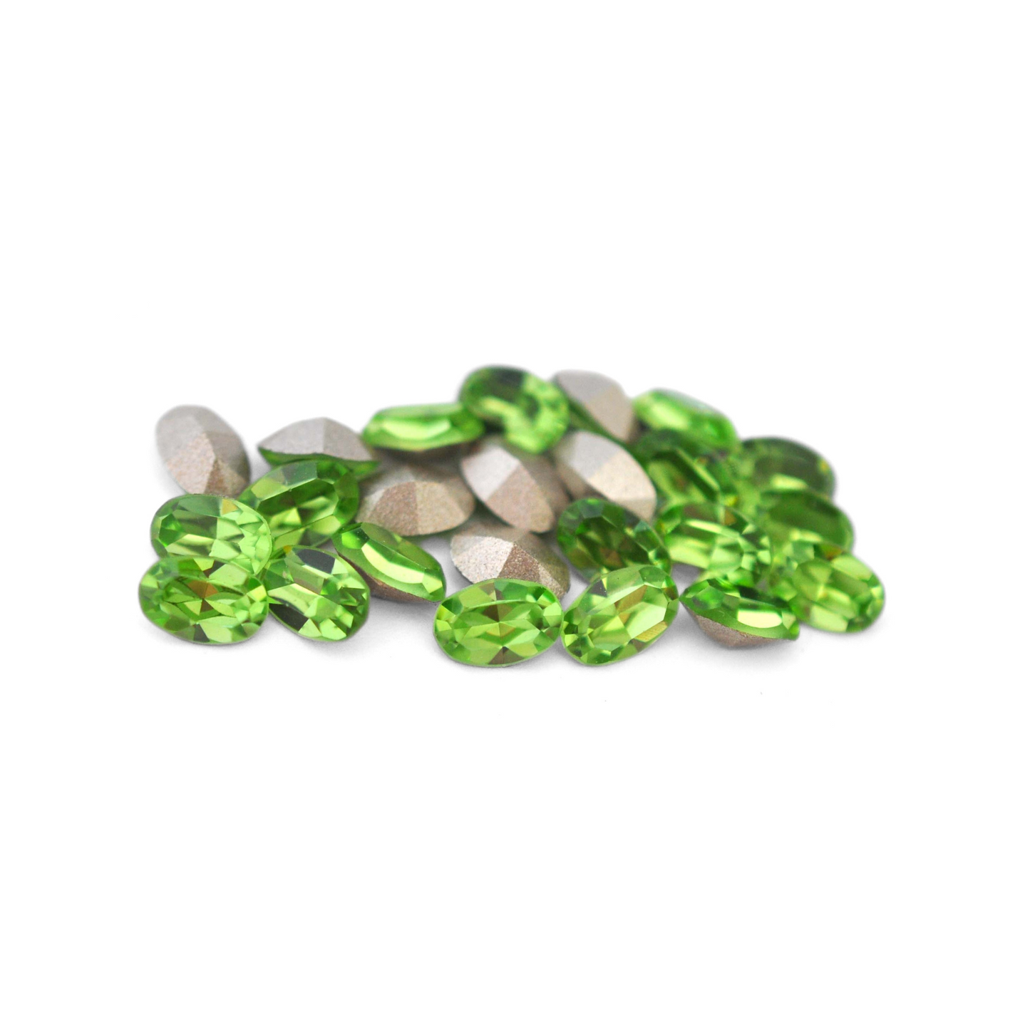 Oval shaped faceted Austrian crystal rhinestones in the color Peridot displayed on a white background.