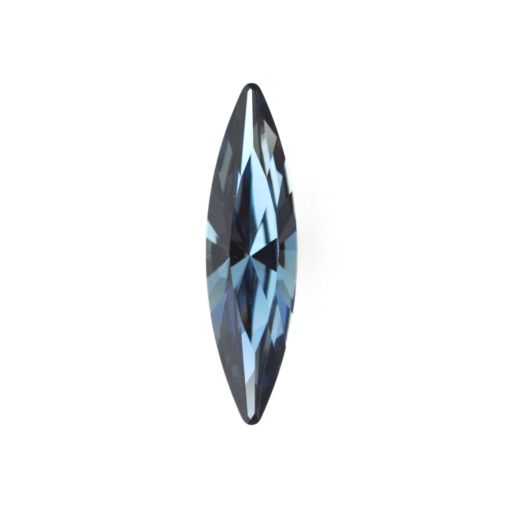 One large navette shape faceted Austrian crystal rhinestones in the color Denim Blue displayed on a white background.