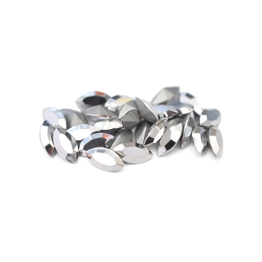 Navette shaped faceted Austrian crystal rhinestones in the color Comet Argent Light displayed on a white background.