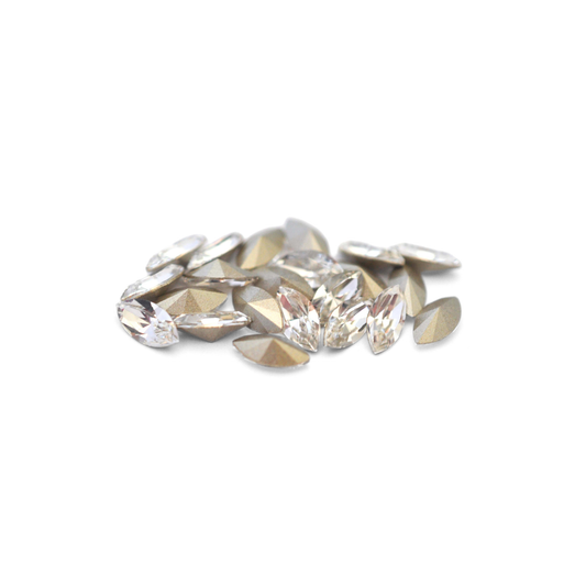 Navette shaped faceted Austrian crystal rhinestones in the color Crystal displayed on a white background.