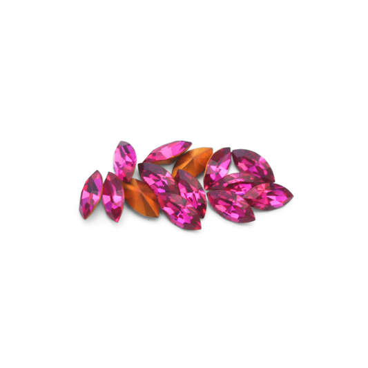 Navette shaped faceted Austrian crystal rhinestones in the color Fuchisa displayed on a white background.