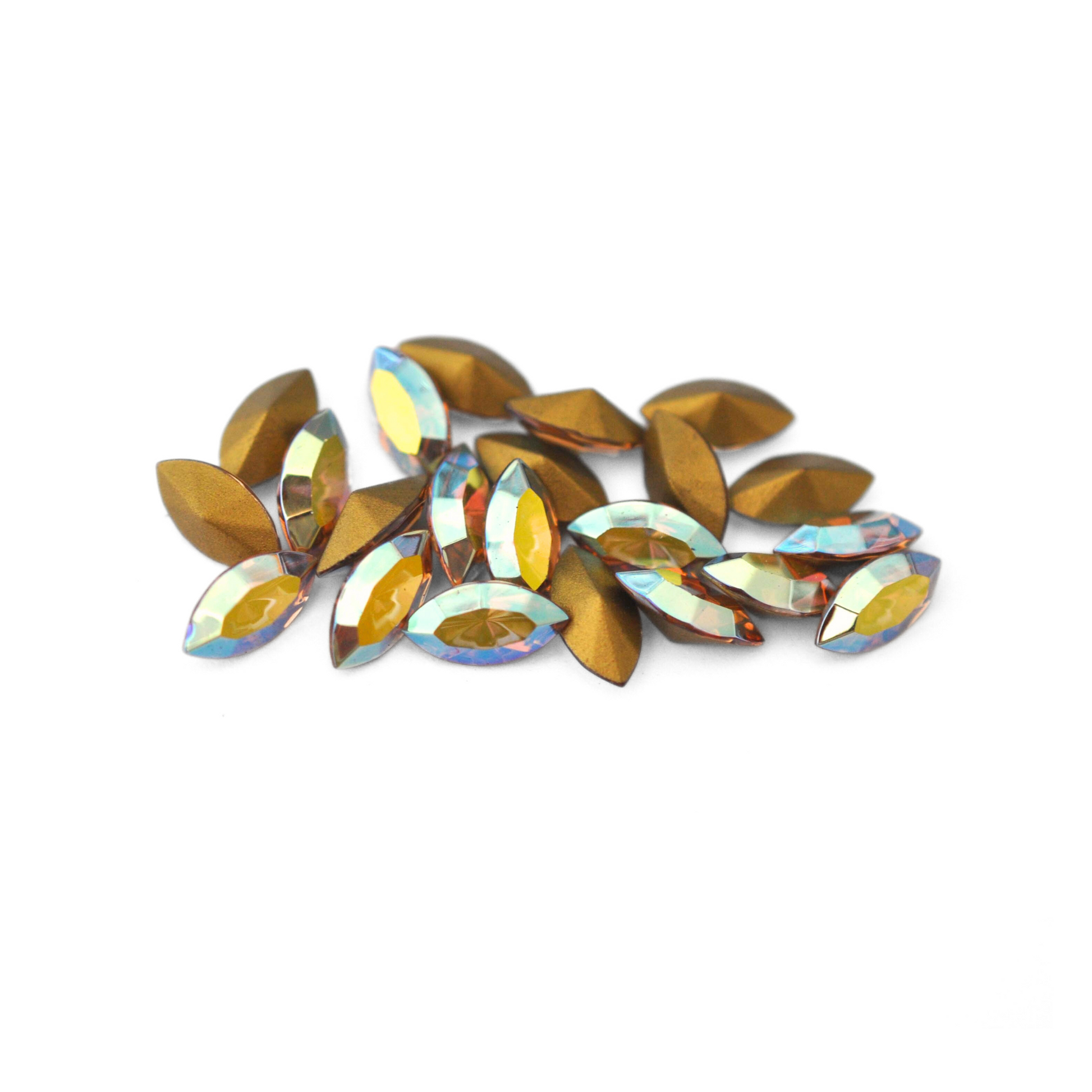 Navette shaped faceted Austrian crystal rhinestones in the color Light Colorado Topaz AB displayed on a white background.