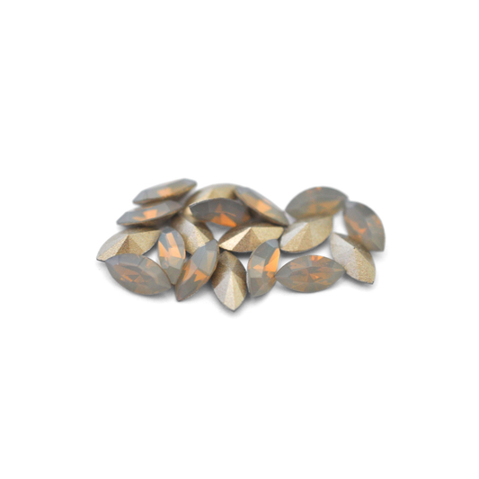 Navette shaped faceted Austrian crystal rhinestones in the color Light Grey Opal displayed on a white background.