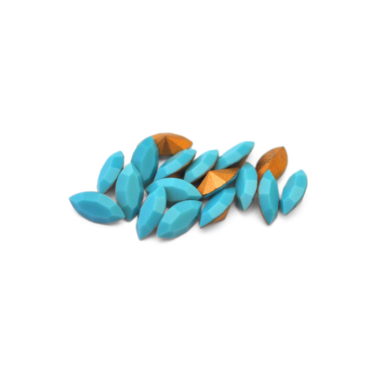 Navette shaped faceted Austrian crystal rhinestones in the color Turquoise displayed on a white background.