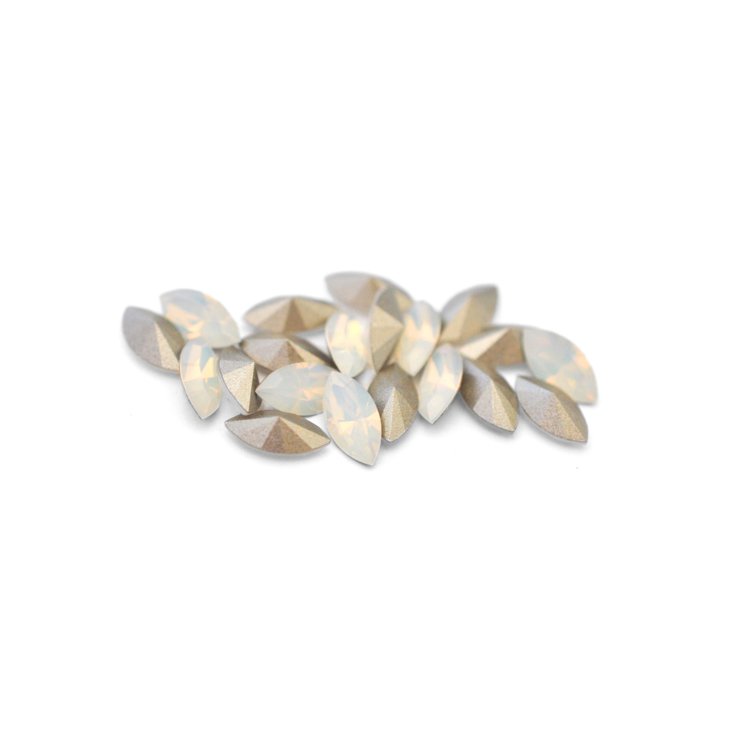 Navette shaped faceted Austrian crystal rhinestones in the color White Opal displayed on a white background.