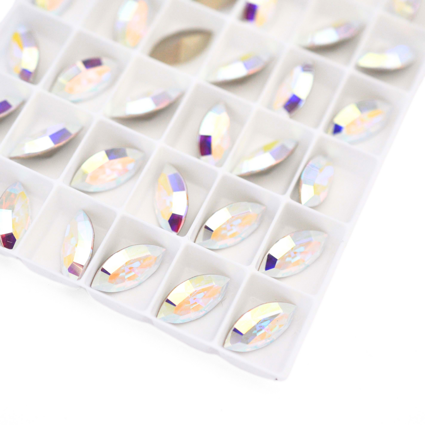 Navette shaped faceted Austrian crystal rhinestones in the color Crystal AB displayed on a white background.