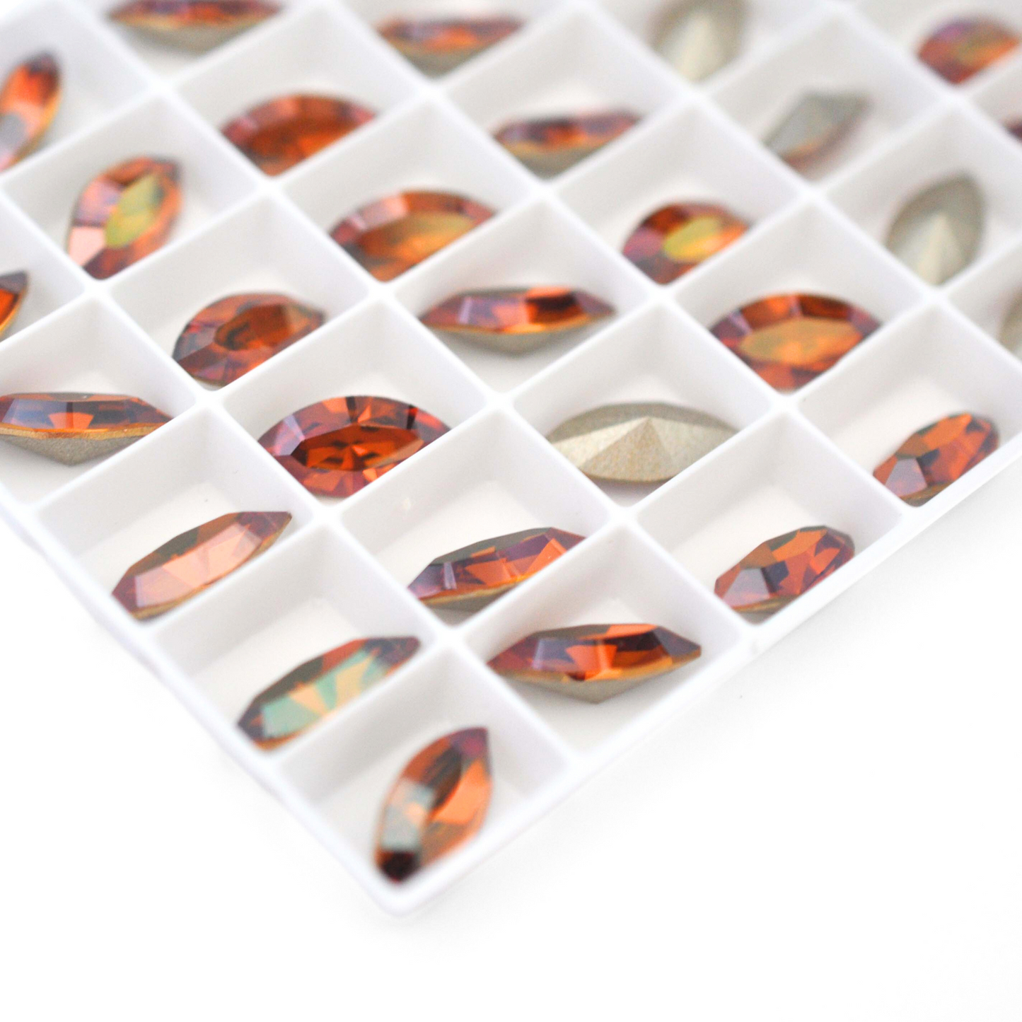 Navette shaped faceted Austrian crystal rhinestones in the color Copper displayed on a white background.