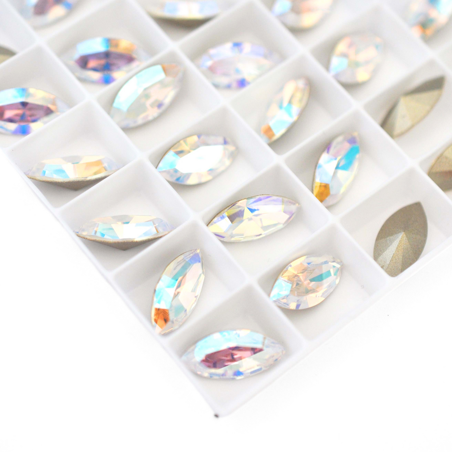 Navette shaped faceted Austrian crystal rhinestones in the color Crystal Shimmer displayed on a white background.