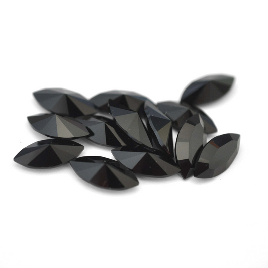 Navette shaped faceted Austrian crystal rhinestones in the color Jet Black displayed on a white background.