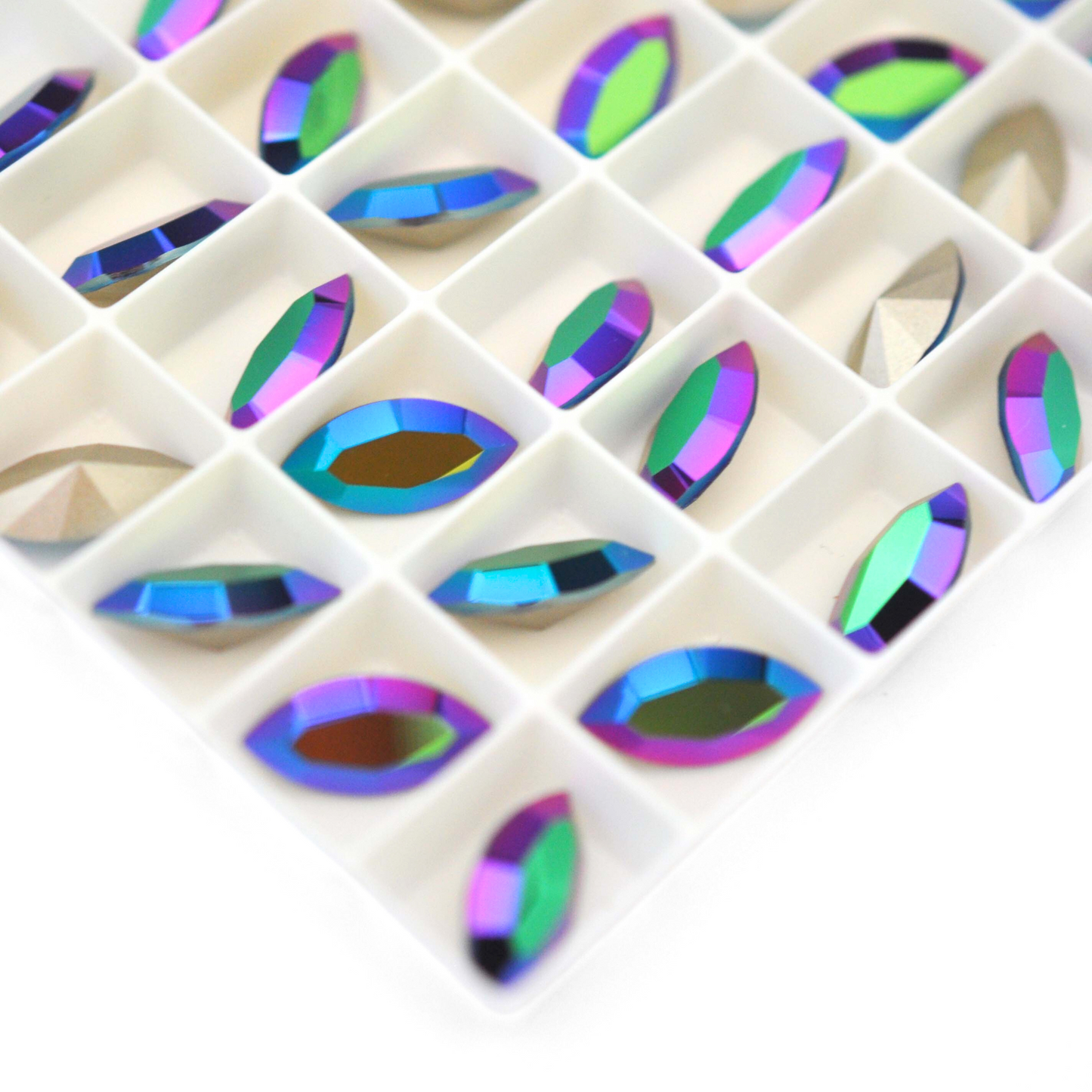 Navette shaped faceted Austrian crystal rhinestones in the color Jet AB displayed on a white background.