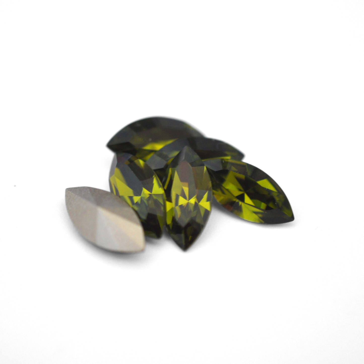 Navette shaped faceted Austrian crystal rhinestones in the color Olivine displayed on a white background.