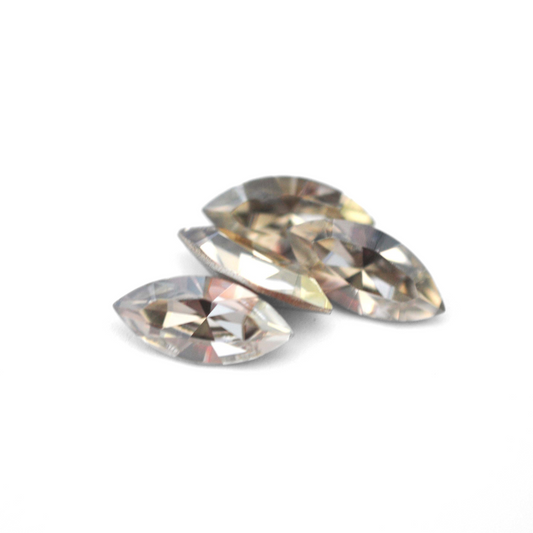Navette shaped faceted Austrian crystal rhinestones in the color Silver Shade displayed on a white background.