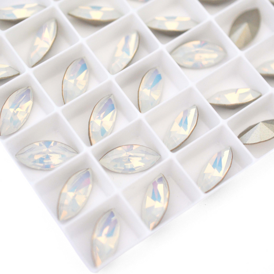 Navette shaped faceted Austrian crystal rhinestones in the color White Opal displayed on a white background.