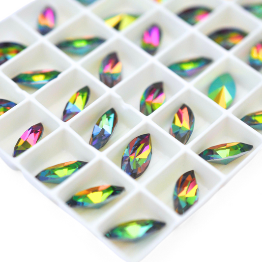 Navette shaped faceted Austrian crystal rhinestones in the color Iridis displayed on a white background.