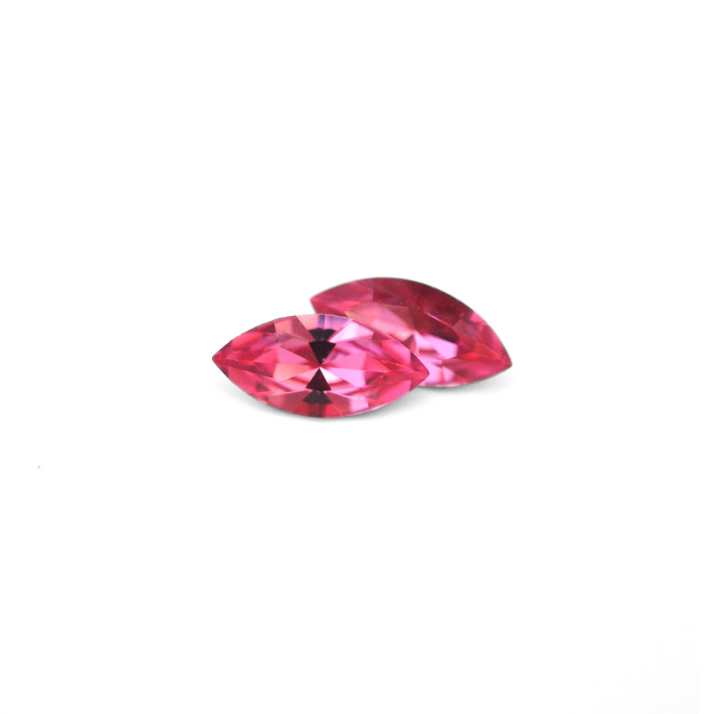 Navette shaped faceted Austrian crystal rhinestones in the color Rose displayed on a white background.