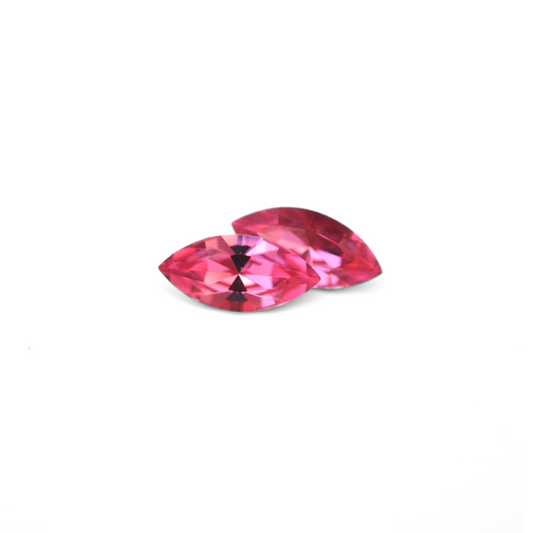 Navette shaped faceted Austrian crystal rhinestones in the color Rose displayed on a white background.
