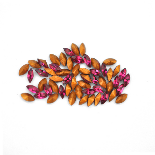 Navette shaped faceted Austrian crystal rhinestones in the color Fuchsia displayed on a white background.