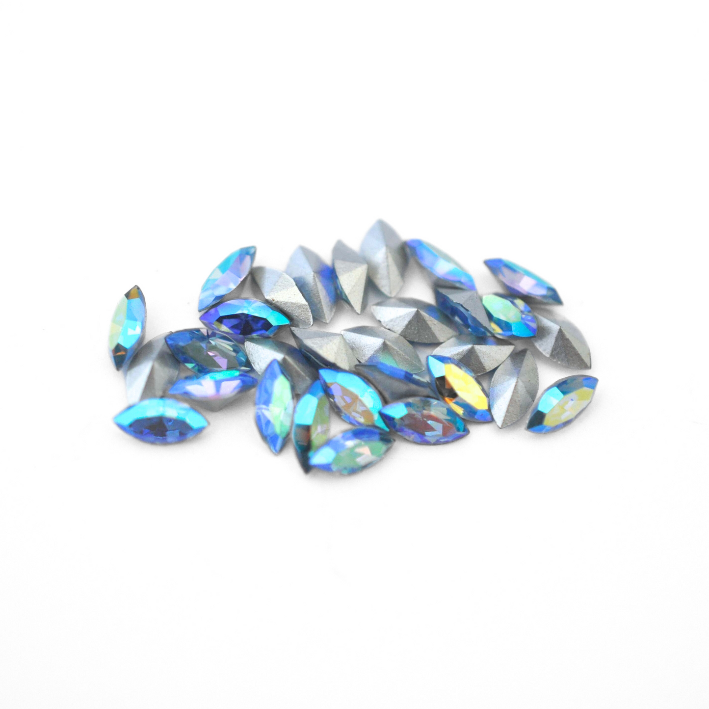 Navette shaped faceted Austrian crystal rhinestones in the color Light Sapphire AB displayed on a white background.