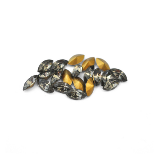 Navette shaped faceted Austrian crystal rhinestones in the color Black Diamond displayed on a white background.