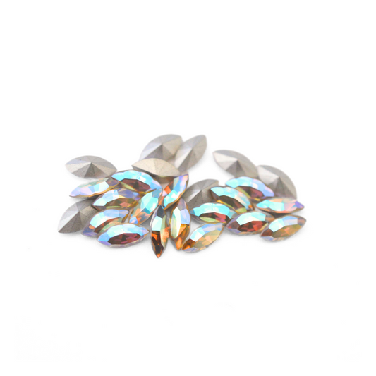 Navette shaped faceted Austrian crystal rhinestones in the color Jonquil AB displayed on a white background.