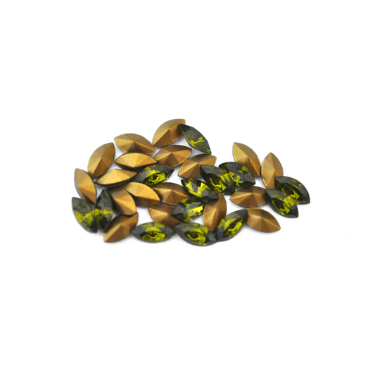 Navette shaped faceted Austrian crystal rhinestones in the color Olivine displayed on a white background.