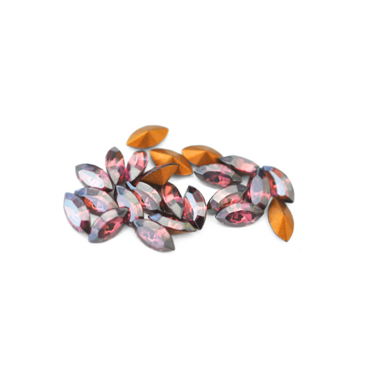 Navette shaped faceted Austrian crystal rhinestones in the color Rose Satin displayed on a white background.