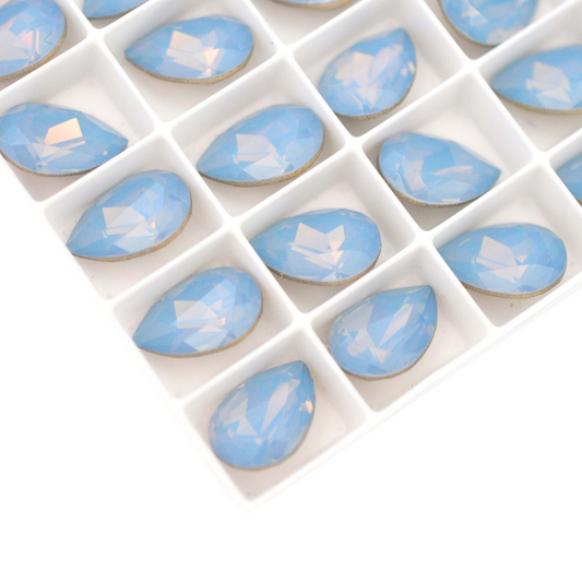 Pear shape faceted Austrian crystal rhinestones in the color Air Blue Opal displayed on a white background.