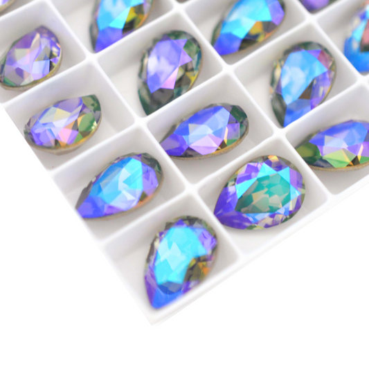 Pear shape faceted Austrian crystal rhinestones in the color Black Diamond Glacier Blue displayed on a white background.