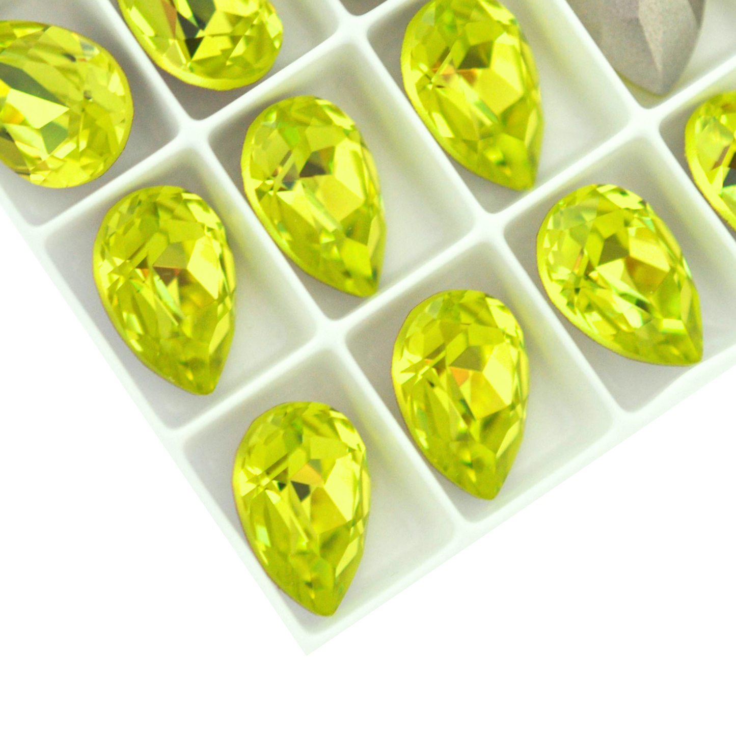Pear shape faceted Austrian crystal rhinestones in the color Citrus Green displayed on a white background.