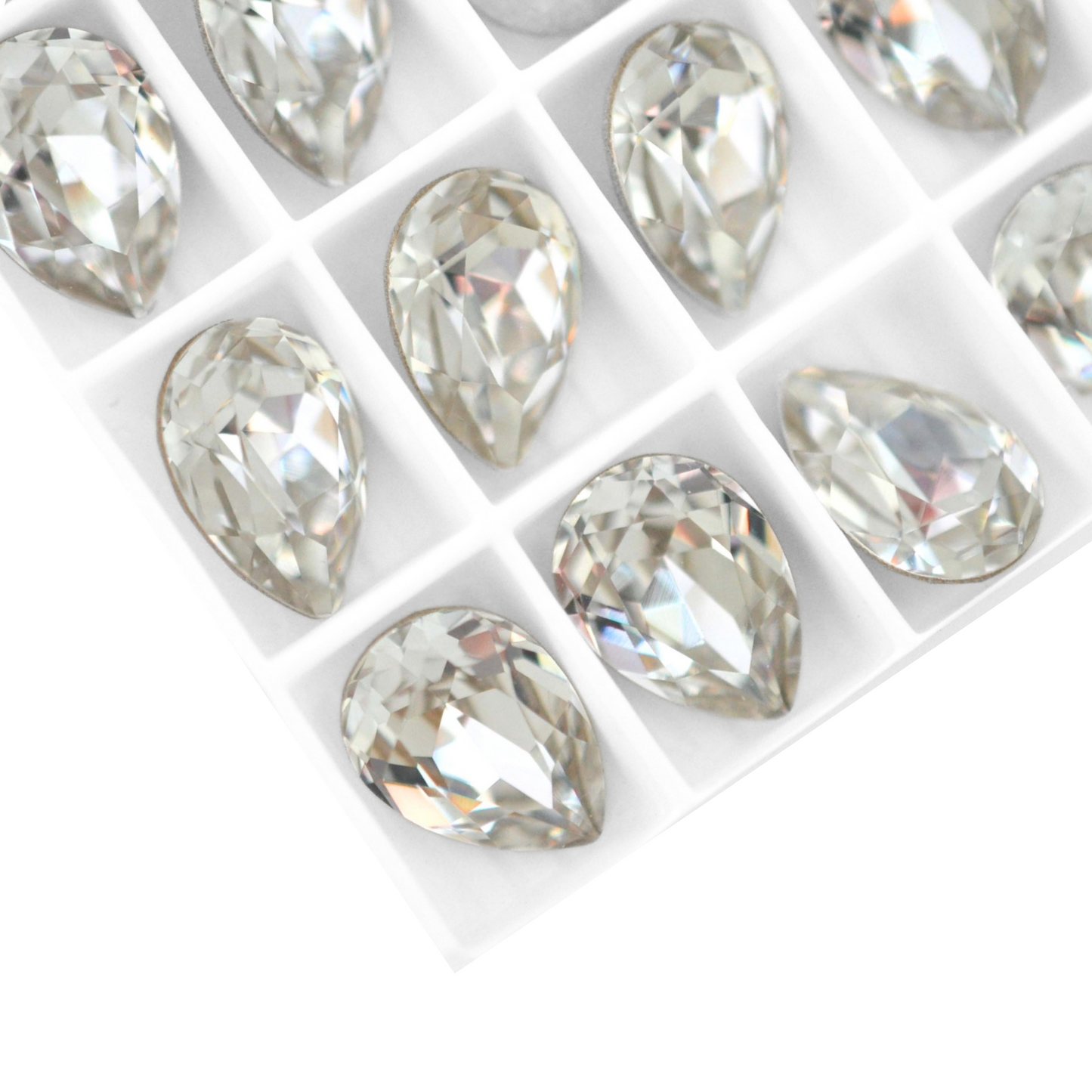 Pear shape faceted Austrian crystal rhinestones in the color Crystal displayed on a white background.