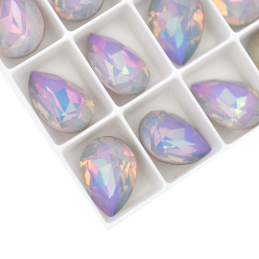 Pear shape faceted Austrian crystal rhinestones in the color Dreamy Vitrail displayed on a white background.